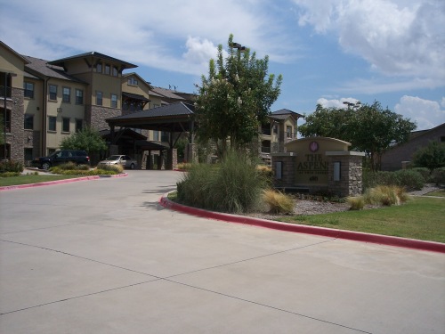 A covered driveway provides a convenient entry to The Aspens main building during all weather conditions. Parking places are on one side of the circular driveway. Residents have parking places inside the gated area. 
